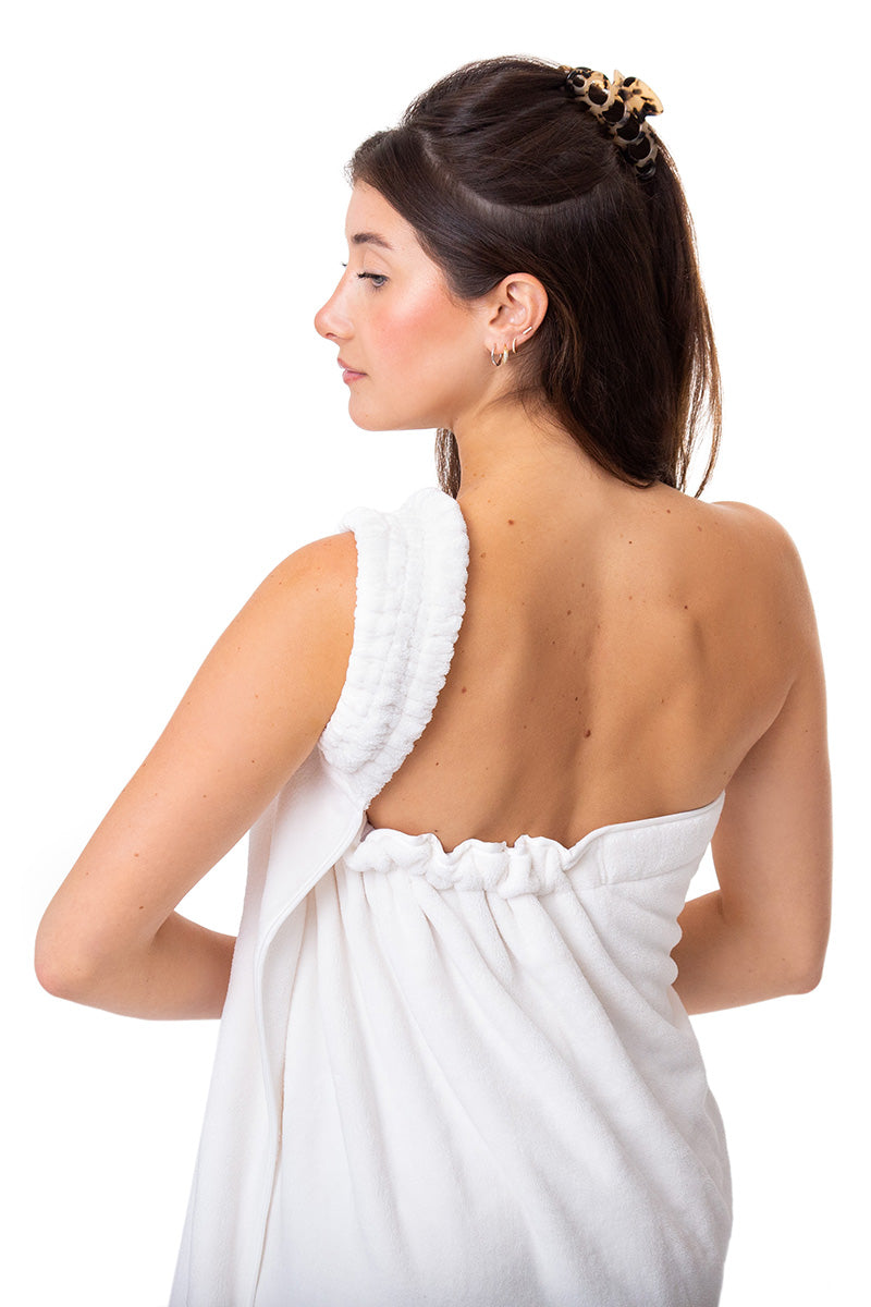 Toga Towel stays in place while woman styles her hair and applies her makeup find at https://toga-towel.com